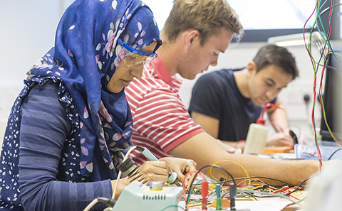 Three students in electronics lab